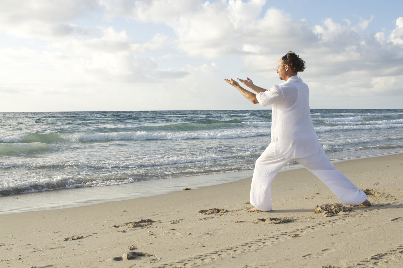Man Practicing Qigong at the Beach